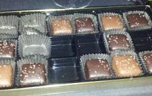 A photo of a box of chocolates with a few missing.