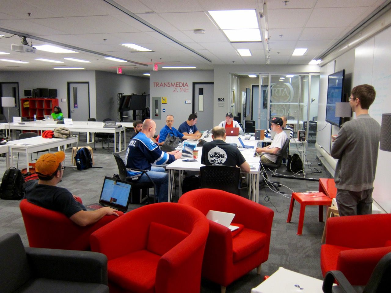 DrupalNorth 2015 sprinters sitting around a table, introducing themselves.